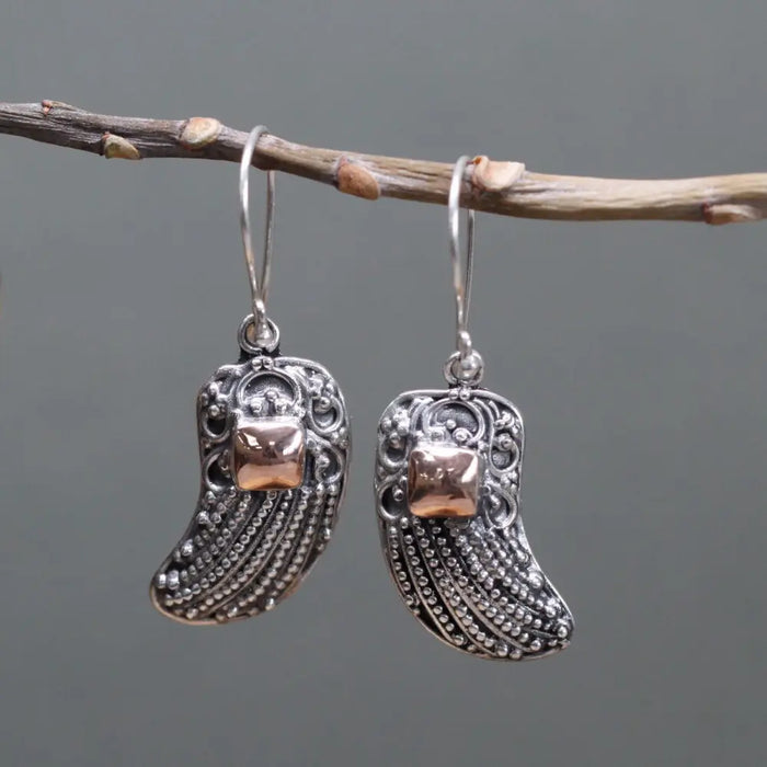 Sterling silver angel wing earrings with intricate filigree and 18ct yellow gold square accent at the center