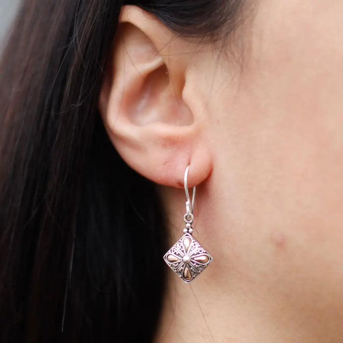 Silver dangle earring with ornate diamond-shaped sterling silver pendant and 18ct yellow gold classic square detail