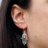 Sterling silver hamsa hand earring with intricate filigree and a small 18ct yellow gold bead at the center