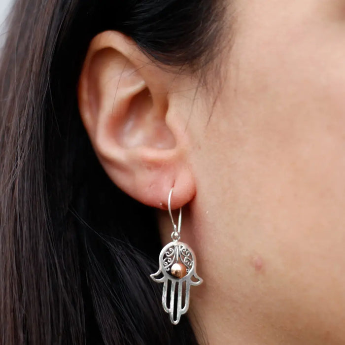 Sterling silver hamsa hand earring with intricate filigree and a small 18ct yellow gold bead at the center
