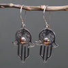 Sterling silver hamsa earrings with intricate filigree and a central 18ct yellow gold bead detail