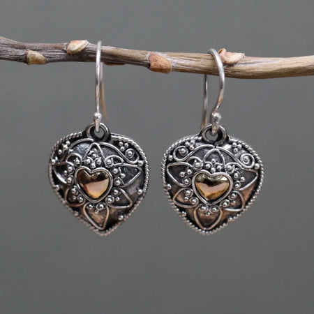 Sterling silver heart-shaped earrings with intricate filigree and a central 18ct yellow gold heart accent
