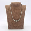 Sterling silver chain necklace with three detailed charm beads and 18ct yellow gold spacers