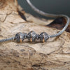 Sterling silver and 18ct yellow gold necklace with charm beads and spacers on a braided metal chain