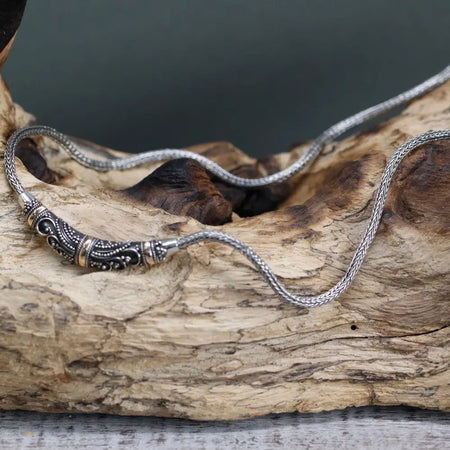 Sterling silver chain necklace with intricate tribal pattern clasp featuring 18ct yellow gold and black detailing