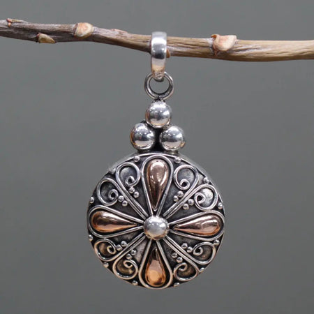A sterling silver and 18ct yellow gold classic round drop pendant with a silver and rose gold filigree teardrop design