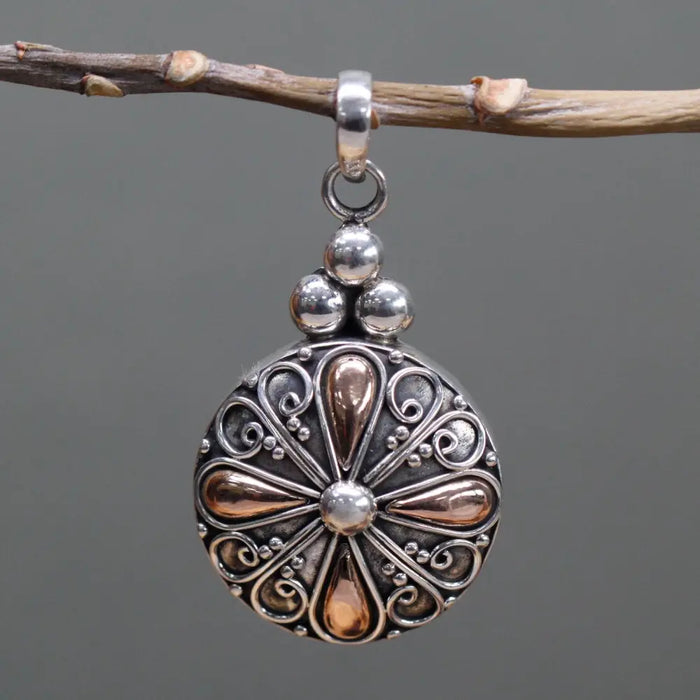 A sterling silver and 18ct yellow gold classic round drop pendant with a silver and rose gold filigree teardrop design