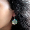 Sterling silver earrings with circular abalone shell and silver filigree floral design in green and blue tones
