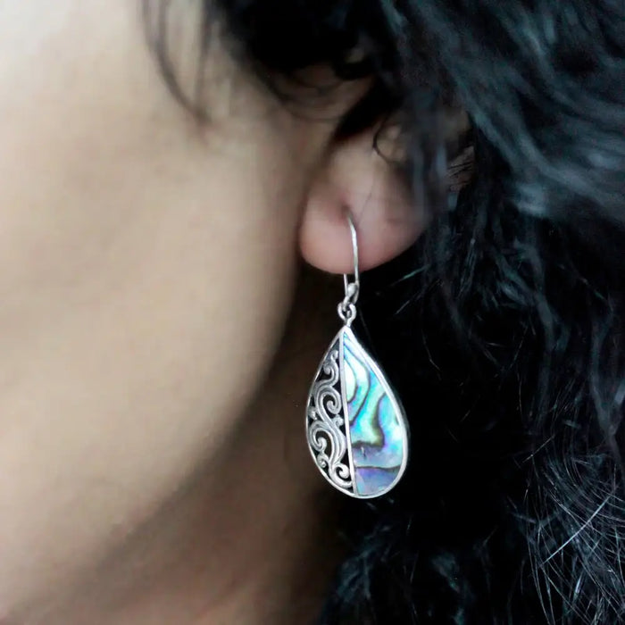 Sterling silver teardrop earrings with filigree detailing and vibrant iridescent abalone shell inlay