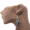 Sterling silver dangle earrings with teardrop abalone shell pendant and three small heart charms in blue and green hues