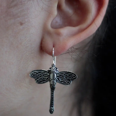 Sterling silver earrings shaped like dragonflies with intricate filigree wings and a beaded silver body