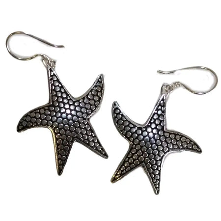 Sterling silver earrings shaped like starfish with a textured dotted surface and silver hook closures