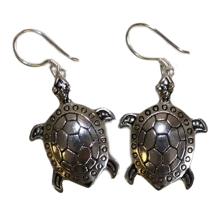 Sterling silver earrings shaped like turtles with detailed shell patterns and small circular silver embellishments on edges