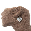 Silver heart-shaped earring with detailed sea turtle design and translucent mother-of-pearl shell in sterling silver