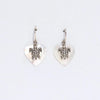 Sterling silver sea turtle charm earrings with heart shaped mother of pearl pendants on a white background
