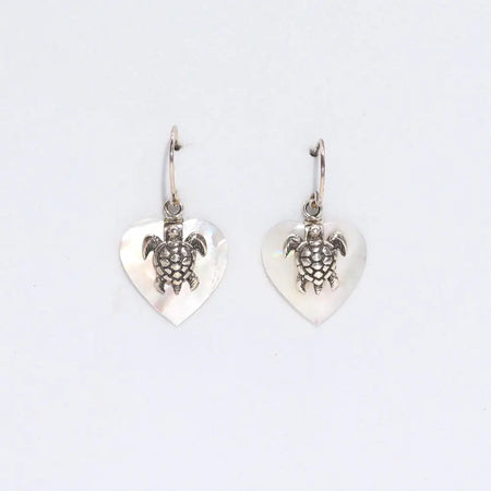 Sterling silver sea turtle charm earrings with heart shaped mother of pearl pendants on a white background