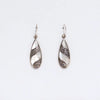 Sterling silver teardrop earrings with intricate swirling patterns and a white mother of pearl inlay