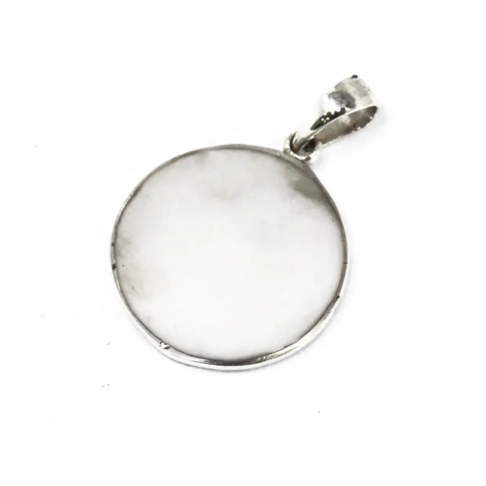 Sterling silver mother of pearl pendant with light stone inset and polished circular frame in tree of life design