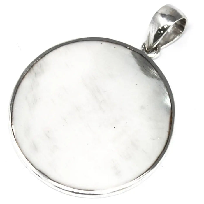 Sterling silver circular pendant with smooth white mother of pearl center and polished metal edges in tree of life design