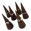 Dark brown wooden ring cones displaying sterling silver stackable rings with a beaded design