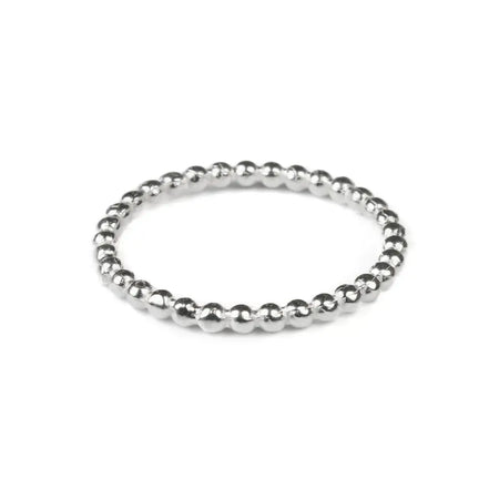 A sterling silver stackable ring with a delicate beaded design featuring small evenly spaced silver beads