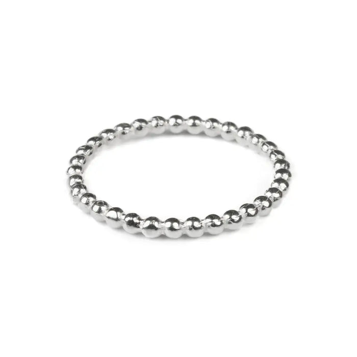 A sterling silver stackable ring with a delicate beaded design featuring small evenly spaced silver beads