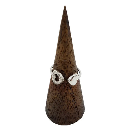 Sterling silver double heart ring with cubic zirconia stones on one side and polished smooth on the other on a wooden cone