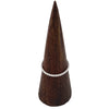 A sterling silver stackable ring with a delicate rope design displayed on a dark wooden cone