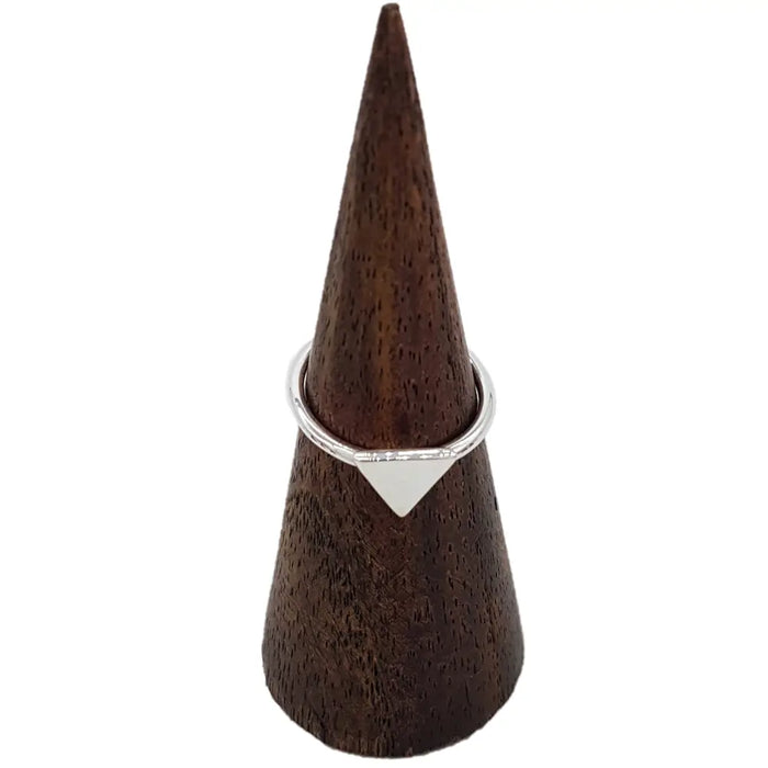 A sleek sterling silver stackable ring with a minimalist solid triangle design in silver color