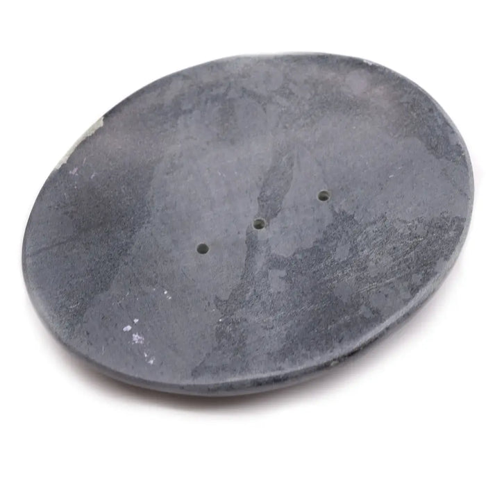 Dark gray classic oval soap dish made of soapstone with a textured surface and three small drainage holes