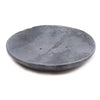 Gray soap dish made of soapstone with a classic oval shape and three small drainage holes and a smooth texture