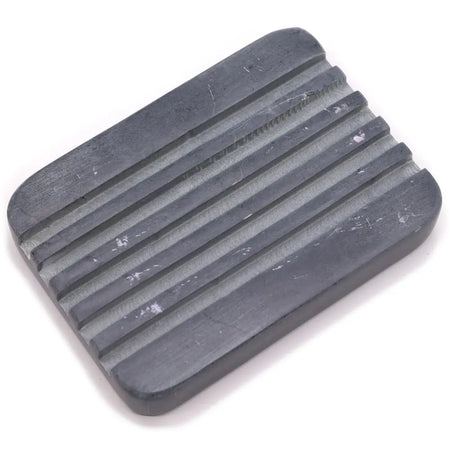 Dark gray rectangular soap dish made of grey soapstone with deep ridges and rounded edges for soap storage