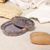 Dark brown speckled soap dish with matching lid and oval drainage cutout made of soapstone stone soap dish