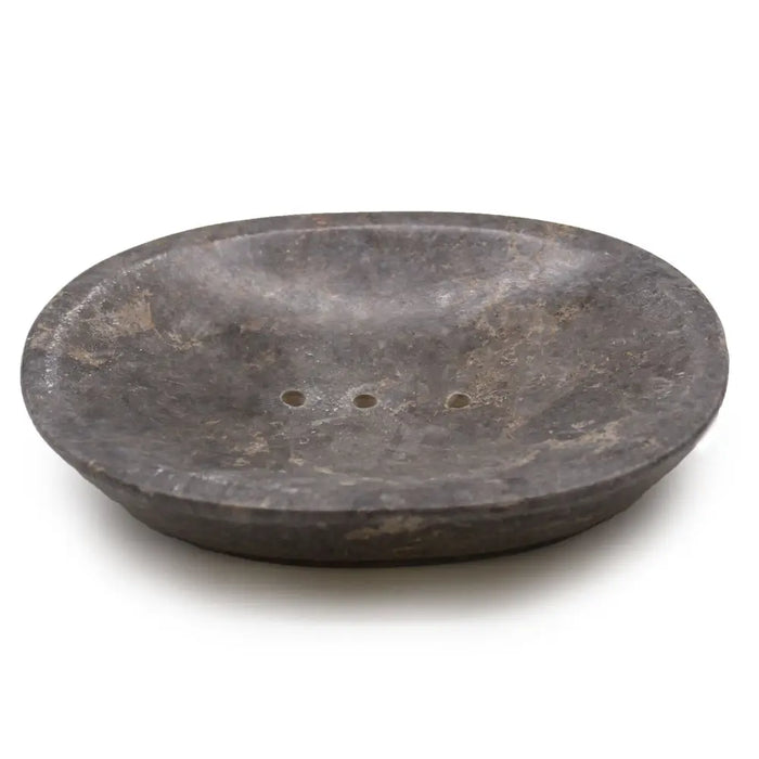 Dark gray stone soap dish with three small drainage holes made of grey marble in an oval shape