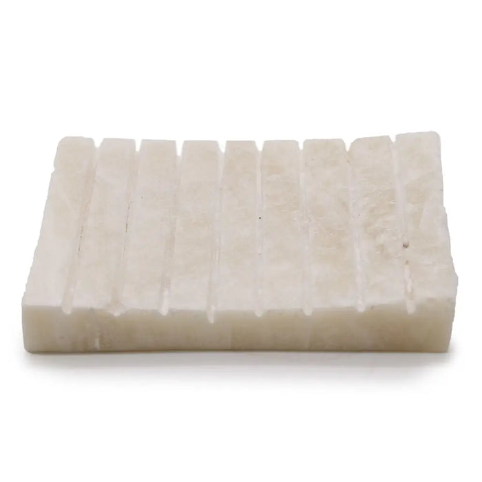 Cream-colored rectangular soap dish with ridged textured surface made of white onyx stone soap dish