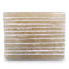 A rectangular translucent honey onyx soap dish with horizontal ridges and a natural rough stone texture