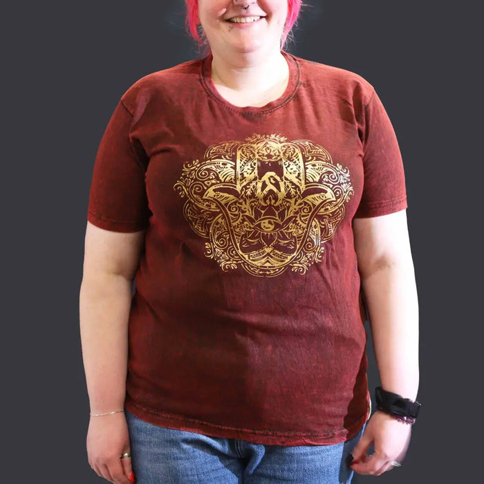 A maroon stonewashed cotton t shirt with short sleeves and a gold embossed hamsa hand design on the front xl size