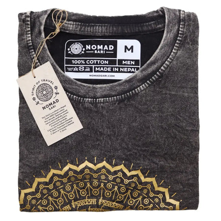 A dark grey stonewashed cotton t shirt with a gold mandala design and freedom text in medium size