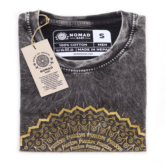Stonewashed cotton t-shirt in dark grey with a distressed look and gold mandala design featuring freedom text along bottom edge