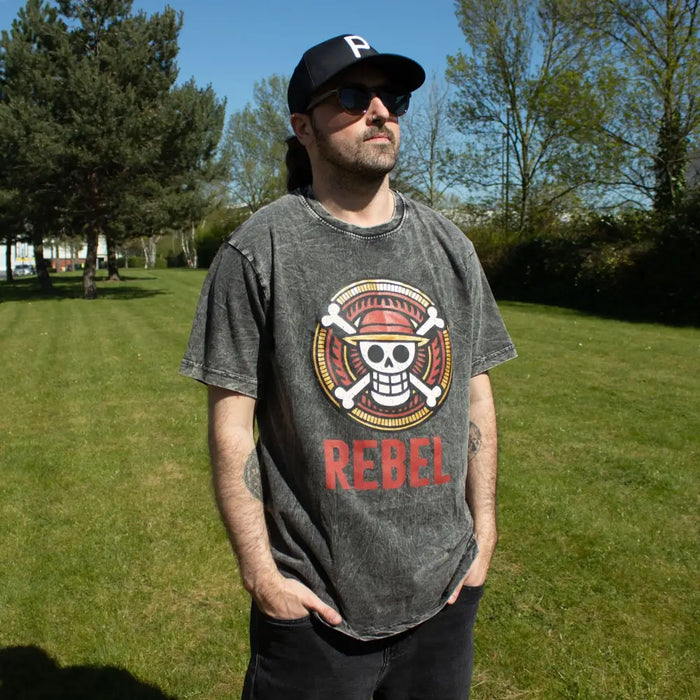 Gray stonewashed cotton t-shirt with a circular skull and crossbones emblem and red text below in charcoal large size