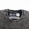 A faded charcoal stonewashed cotton t-shirt with a distressed texture and nomad sari label made in nepal in small size