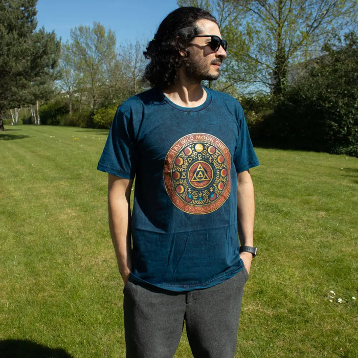 A navy blue stonewashed cotton t-shirt with a gold red moon phases design for stay wild moon child fans