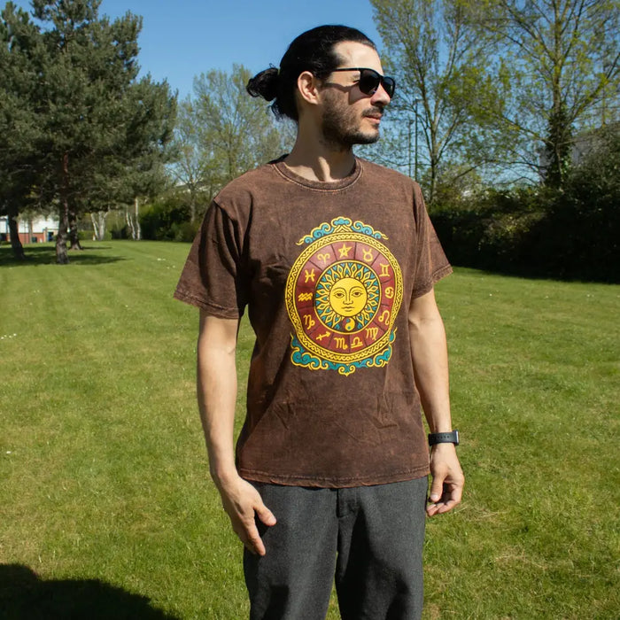 Brown stonewashed cotton t shirt with short sleeves and a sun zodiac graphic in gold red and teal detailing