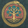 Dark green stonewashed cotton t-shirt with a circular emblem of a golden serpent coiled around a stylized tree of life