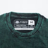 Stonewashed cotton dark green unisex t-shirt with a faded textured finish and black ribbed crew neck in medium size