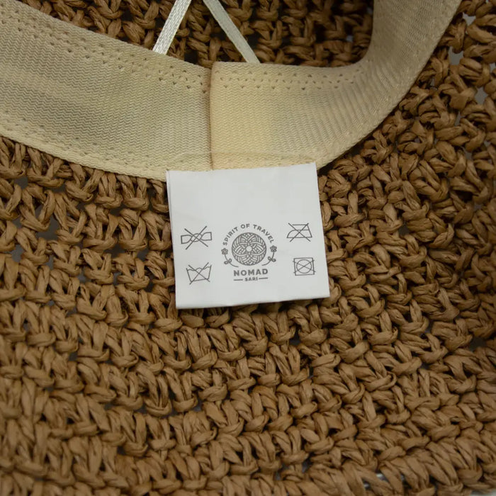 Beige straw sun hat with woven straw material and matching fabric band from coffee and daisies collection