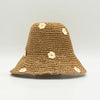 A tan crocheted straw sun hat with small white daisy flowers called coffee and daisies sun hat