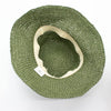 Olive green woven straw sun hat with cream fabric band shown against plain background for sun protection