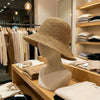 Beige woven straw sun hat with wide brim and textured pattern in natural coffee color for outdoor use