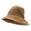 A woven straw sun hat in natural coffee color with a wide brim and textured natural straw material